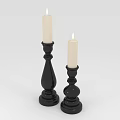 Two Ornate Black Candle Holders With White Candles And Classic Bases For Home Decor