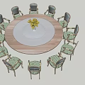 Round Dining Table Set With Green Patterned Chairs And White Plate Yellow Flowers