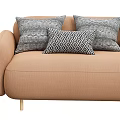 Beige Upholstered Sofa With Multiple Geometric Patterned Pillows And Gold Metal Legs