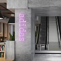 Modern Clothing Store Interior With Open Layout Display Racks Pendant Lights And Green Plants