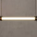 Modern Minimalist Pendant Light with Long Tube Design Hanging via Chains on Gray Wall