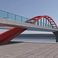 Modern Landscape Bridge With Red Arch Structure Spanning Water And Riverbank Pavement