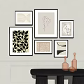 Stylish Wall Decor With Various Framed Artworks And Decorative Glass Bottles