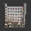 Old Style Multi Story Building With Colored Windows Ground Floor Shops And Exterior Signboards