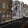 Historic Commercial Street Scene On Rainy Day With Red Telephone Booth And Pedestrians