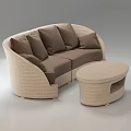 Curved Beige Wicker Sectional Sofa With Dark Brown Cushions And Matching Round Coffee Table