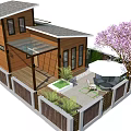 Wooden Vacation Rental Building With Deck Green Plants Outdoor Seating And Pink Flowering Tree