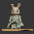 Cute Rabbit Doll Wearing Floral Green Dress Standing On Wooden Platform