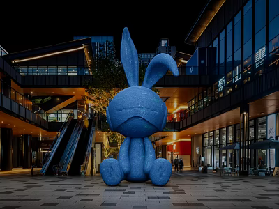 Blue Rabbit Inflatable Model In Outdoor Commercial Plaza At Night With Buildings Escalator And Lighting 3d model