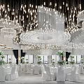 Elegant Banquet Hall With Chandeliers White Tables Green Floral Decorations And Central Flower Pathway