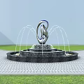 Garden Ornament Silver Sculpture Fountain With Water Jets Black Base On Paved Grass Area