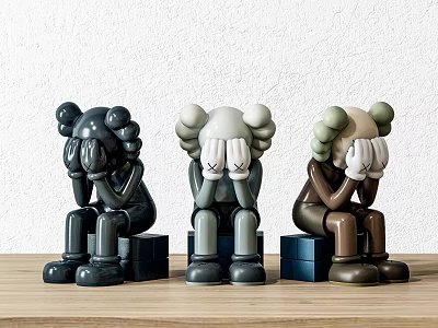 Three Black Gray Brown Cartoon Decorative Figurine Combination With Blue Cube Bases On Wooden Table 3d model