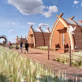 A Frame Wooden Cabins With Pathway Green Grass And Blue Sky View