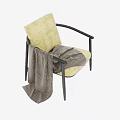 Yellow Cushioned Armchair with Black Armrests Legs and Plaid Blanket Draped