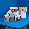 Vintage Digital Cameras With Colorful Designs Displayed On Blue Platform Stand