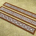Wooden Carved Decorative Strips With Intricate Openwork Patterns On Textured Surface 3d model