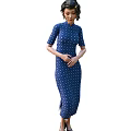 A Woman Wearing a Traditional Blue Qipao With White Polka Dots