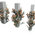 Decorative Orange And White Flowers With Green Leaves Around Gray Pillars