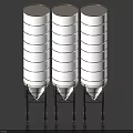 Three Vertical Cylindrical Industrial Storage Tanks With Supporting Frames For Material Storage