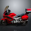 Sleek Red Cruiser Motorcycle With Windshield Black Seat And Rear Luggage Case