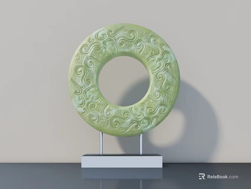 Green Circular Sculpture Carving With Intricate Patterns On White Stand And Gray Table 3d model 