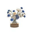 Transparent Vase With White Peonies And Blue Thistles On Wooden Base With Fairy Lights