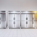 Stainless Steel Commercial Kitchen Appliances Arranged Side by Side in White Tiled Kitchen