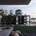Modern Detached Villa With Glass Facade Water Pool Outdoor Lawn And Sunset Sky