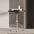 Modern Side Table With Round Black Top Metal Frame And Stacked Books