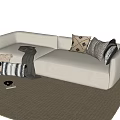 Beige Double Sofa with Patterned Pillows and Gray Throw Blanket on Woven Rug 3d model