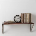 Stacked And Tied Books On Wooden Table With Metal Frame And Clock Against White Wall