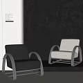 Modern Minimalist Armchair with Black and Beige Upholstery and Silver Metal Frame on Neutral Walls