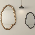 Decorative Mirrors with Gold and Black Irregular Textured Frames on Light Wall and Pendant Light