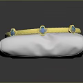 Elegant Gold Textured Bracelet With Blue Gemstones On White Display Cushion