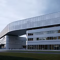 Modern Industrial Park Building With Waterfront Walkway Pedestrians And Retail Shops