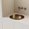 Modern Bathroom Sink with Gold Faucet and Round Basin on White Countertop and Cabinets