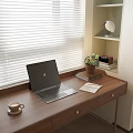 Wooden Desk with Laptop Coffee Cup Notebook Small Plant by Window Blinds Shelf Books Lamp