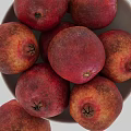 Fresh Red Pomegranates In White Pedestal Bowl With Ripe Juicy Appearance