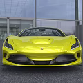 Yellow Convertible Sports Car In Outdoor Setting With Glass Building And Trees