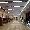 Spacious Modern Service Hall Interior With Waiting Chairs Service Counters Wall Posters And Ceiling Lights