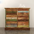Rustic Wooden Dresser With Multi Colored Drawers And Glass Vases On Top