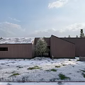 Modern Detached Villa In Snowy Forest Surroundings With Sloped Roof And Snow Covered Trees