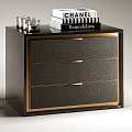 Elegant Black Chest of Drawers with Gold Trim Crocodile Texture and Decorative Books