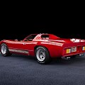 Vintage Red Sports Car Features Sleek Body 4200 Number And Silver Wheels On Dark Floor