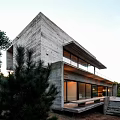 Modern Detached Villa with Concrete Exterior Geometric Design Illuminated Windows Evening View