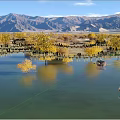 Scenic Landscape Bridge Over Lake Water With Yellow Trees And Mountain Views