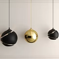 Modern Spherical Pendant Lights In Black And Gold With Decorative Lines On White Wall