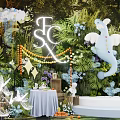 Floral Display With Green Foliage Background White Elephant Decoration And Illuminated Letters
