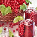 Refreshing Iced Red Berry Drink with Fresh Red Currants Lime Slices and Ice Cubes