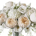 Glass Vase With White And Blush Roses Hydrangeas Small White Flowers And Green Foliage